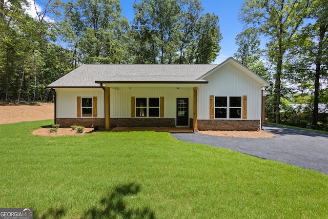 560 Coots Lake Rd, Rockmart, GA 30153 - view of front of home featuring roof with shingles, a front yard, stone siding, and driveway