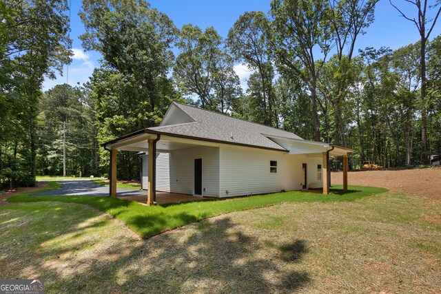 560 Coots Lake Rd, Rockmart, GA 30153 - view of home's exterior featuring a yard, a shingled roof, and a carport