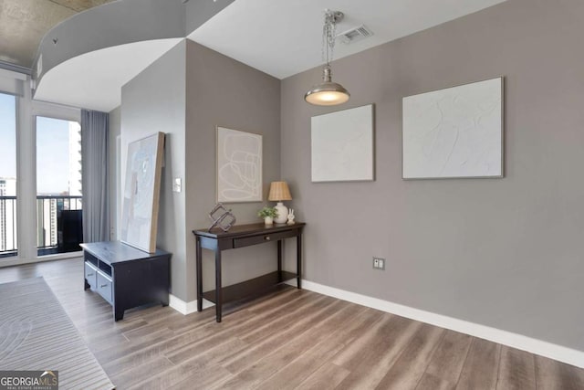 855 Peachtree St NE Unit 1703, Atlanta, GA 30308 - hallway featuring light wood-type flooring and baseboards