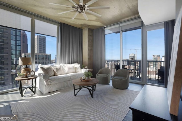 855 Peachtree St NE Unit 1703, Atlanta, GA 30308 - living room featuring a wall of windows, a city view, a ceiling fan, healthy amount of natural light, and wood finished floors