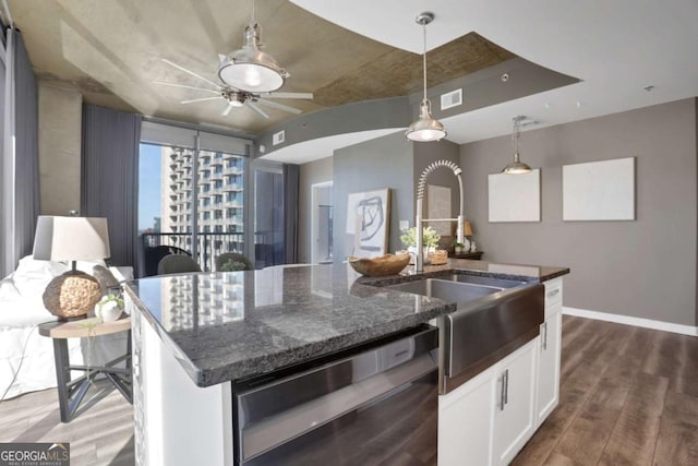 855 Peachtree St NE Unit 1703, Atlanta, GA 30308 - kitchen with dishwashing machine, wood finished floors, white cabinetry, dark stone countertops, and hanging light fixtures