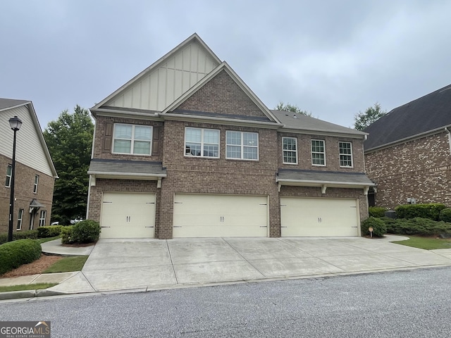 805 Pleasant Hill Rd NW Unit 53, Lilburn, GA 30047 - craftsman-style house featuring board and batten siding, brick siding, a garage, and driveway