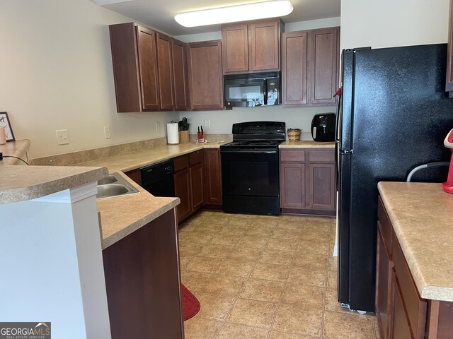 805 Pleasant Hill Rd NW Unit 53, Lilburn, GA 30047 - kitchen with black appliances, a peninsula, and light countertops