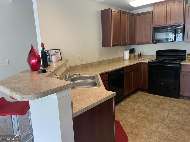 805 Pleasant Hill Rd NW Unit 53, Lilburn, GA 30047 - kitchen featuring black appliances, a sink, a peninsula, and light countertops