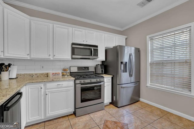 13300 Morris Rd Unit 62, Alpharetta, GA 30004 - kitchen with stainless steel appliances, white cabinetry, baseboards, ornamental molding, and tasteful backsplash