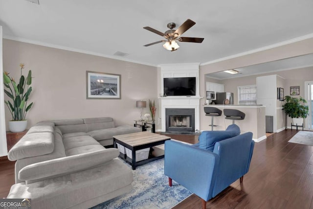 13300 Morris Rd Unit 62, Alpharetta, GA 30004 - living area featuring ornamental molding, a ceiling fan, dark wood-style floors, and a large fireplace