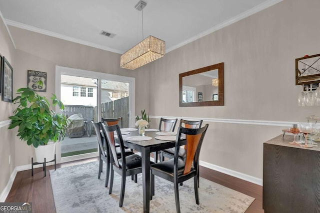 13300 Morris Rd Unit 62, Alpharetta, GA 30004 - dining area featuring baseboards, ornamental molding, and wood finished floors