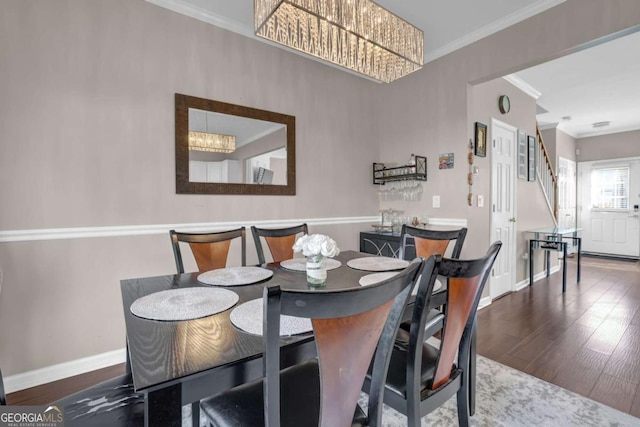 13300 Morris Rd Unit 62, Alpharetta, GA 30004 - dining area featuring crown molding, stairway, a chandelier, baseboards, and wood finished floors