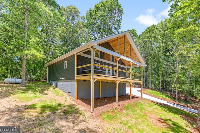 139 Maple Ridge Dr, Cleveland, GA 30528 - rear view of house featuring a deck, an attached garage, and dirt driveway