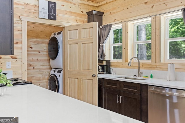139 Maple Ridge Dr, Cleveland, GA 30528 - kitchen featuring a sink, dishwasher, estacked washer and dryer, wood walls, and dark brown cabinets