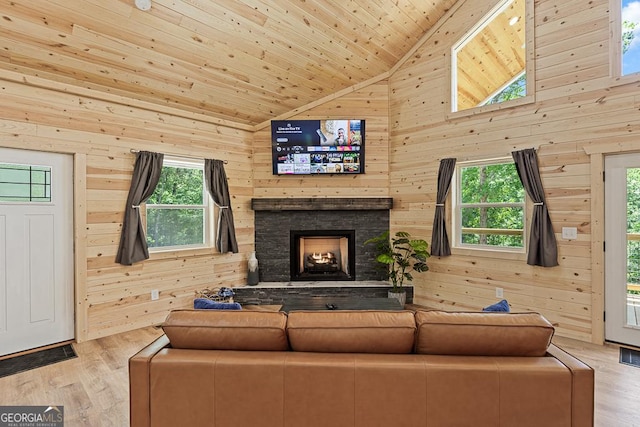 139 Maple Ridge Dr, Cleveland, GA 30528 - living area featuring wood walls, wood finished floors, wooden ceiling, a stone fireplace, and high vaulted ceiling