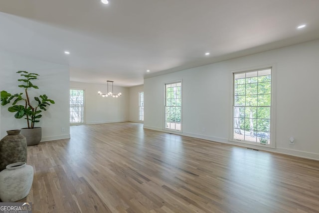 3350 Pine Meadow Rd NW, Atlanta, GA 30327 - unfurnished living room with a chandelier, light wood-style floors, and recessed lighting