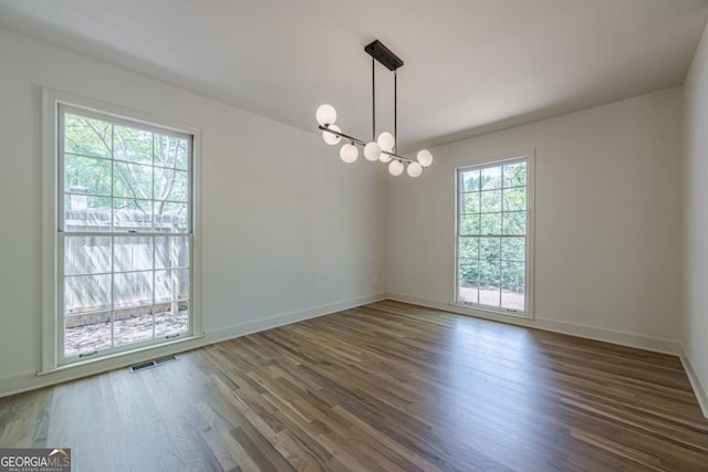 3350 Pine Meadow Rd NW, Atlanta, GA 30327 - unfurnished room with wood finished floors and a chandelier