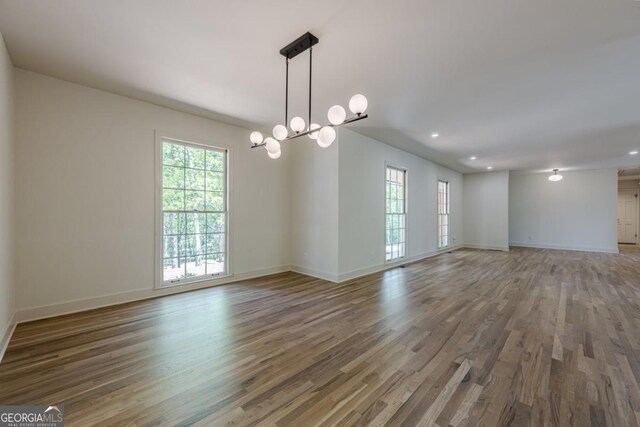 3350 Pine Meadow Rd NW, Atlanta, GA 30327 - spare room with wood finished floors, a chandelier, and recessed lighting
