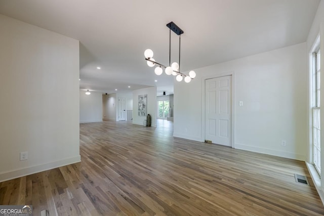 3350 Pine Meadow Rd NW, Atlanta, GA 30327 - unfurnished room featuring a chandelier, wood finished floors, and recessed lighting