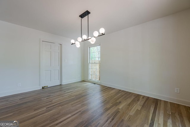 3350 Pine Meadow Rd NW, Atlanta, GA 30327 - spare room featuring a chandelier and wood finished floors