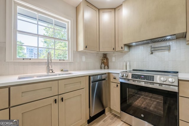 3350 Pine Meadow Rd NW, Atlanta, GA 30327 - kitchen featuring appliances with stainless steel finishes, light countertops, light wood-type flooring, and backsplash