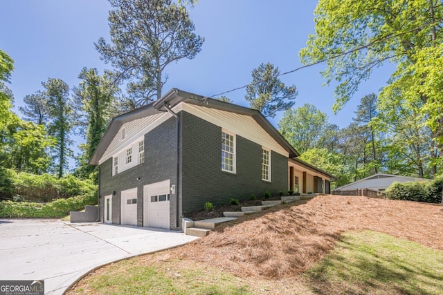 3350 Pine Meadow Rd NW, Atlanta, GA 30327 - view of side of property featuring an attached garage, concrete driveway, and brick siding