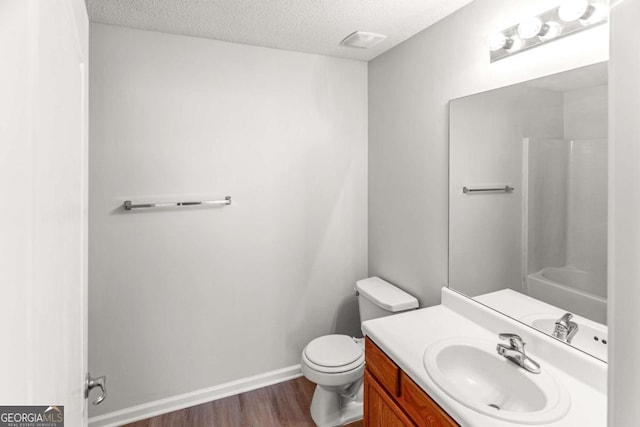 3134 Imperial Cir SW, Atlanta, GA 30311 - full bathroom featuring vanity, a textured ceiling, wood finished floors, and shower / tub combination
