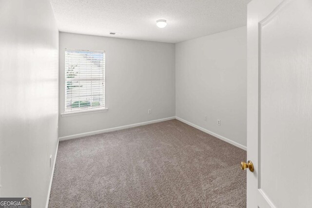 3134 Imperial Cir SW, Atlanta, GA 30311 - carpeted spare room with a textured ceiling and baseboards