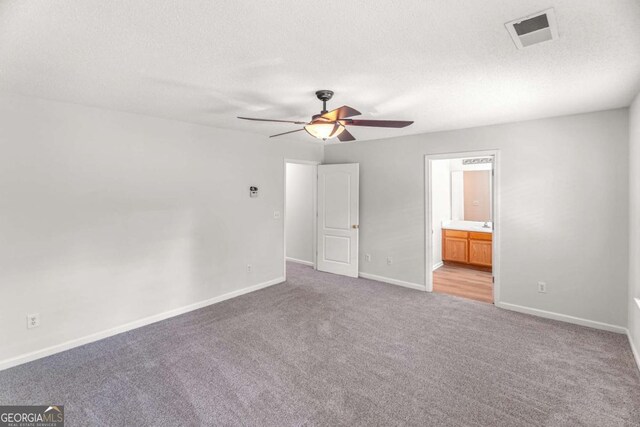 3134 Imperial Cir SW, Atlanta, GA 30311 - unfurnished bedroom featuring light carpet, a textured ceiling, ensuite bathroom, and a ceiling fan