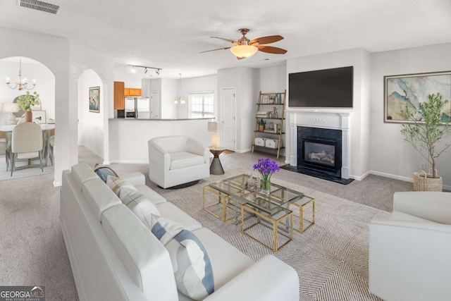 3134 Imperial Cir SW, Atlanta, GA 30311 - living room with light colored carpet, a chandelier, arched walkways, and a ceiling fan