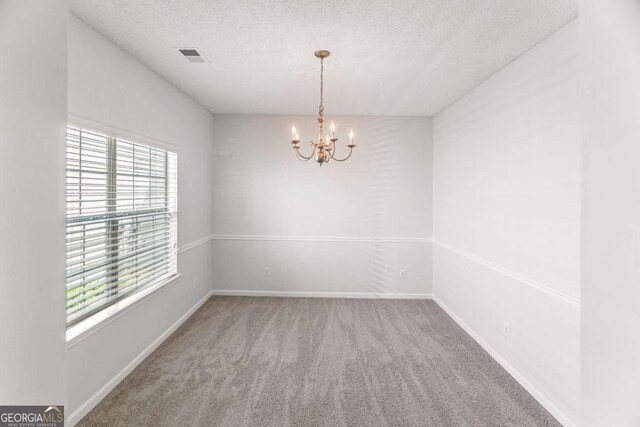 3134 Imperial Cir SW, Atlanta, GA 30311 - empty room featuring healthy amount of natural light, carpet floors, a chandelier, and a textured ceiling