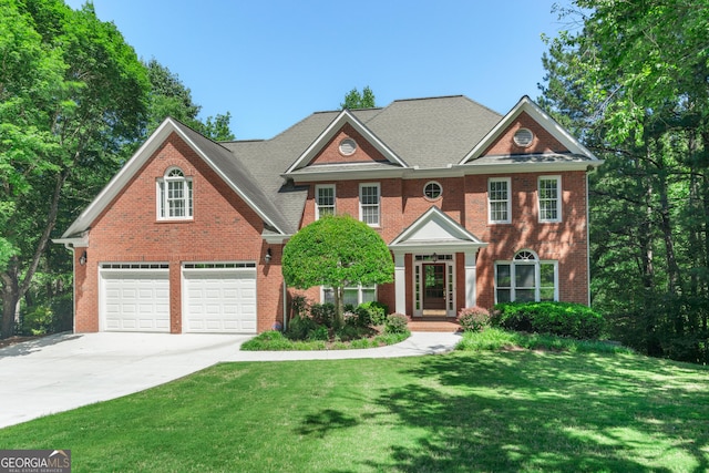 140 Longwater Cv, Roswell, GA 30075 - colonial house with driveway, a front lawn, brick siding, and an attached garage