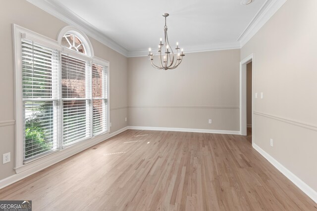 140 Longwater Cv, Roswell, GA 30075 - spare room with healthy amount of natural light, a chandelier, light wood-style flooring, and ornamental molding