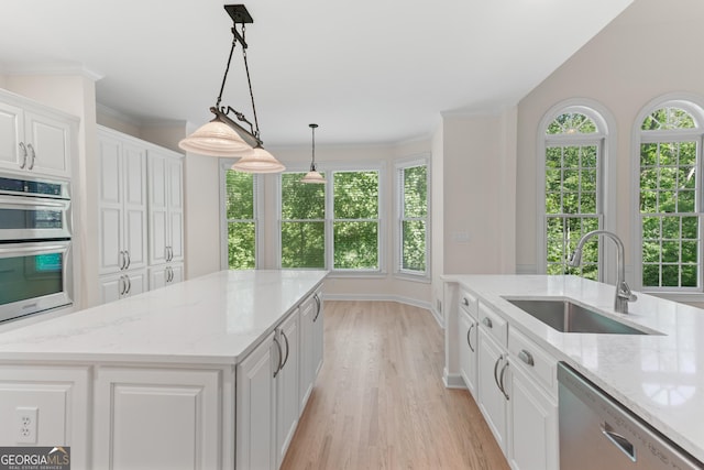 140 Longwater Cv, Roswell, GA 30075 - kitchen featuring appliances with stainless steel finishes, a sink, light wood-type flooring, white cabinets, and plenty of natural light