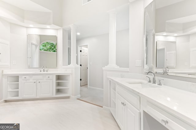 140 Longwater Cv, Roswell, GA 30075 - bathroom featuring decorative columns, two vanities, baseboards, and recessed lighting