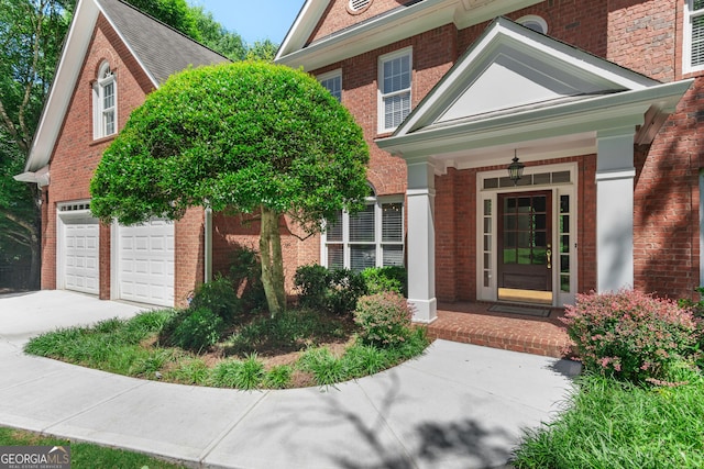 140 Longwater Cv, Roswell, GA 30075 - entrance to property featuring brick siding, concrete driveway, a porch, and a garage