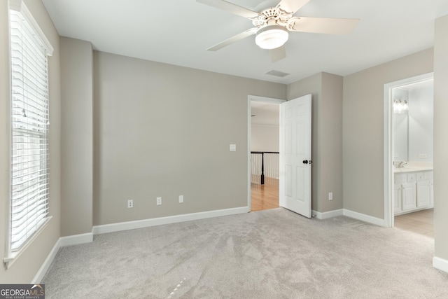 140 Longwater Cv, Roswell, GA 30075 - unfurnished bedroom featuring light colored carpet, baseboards, connected bathroom, and a ceiling fan