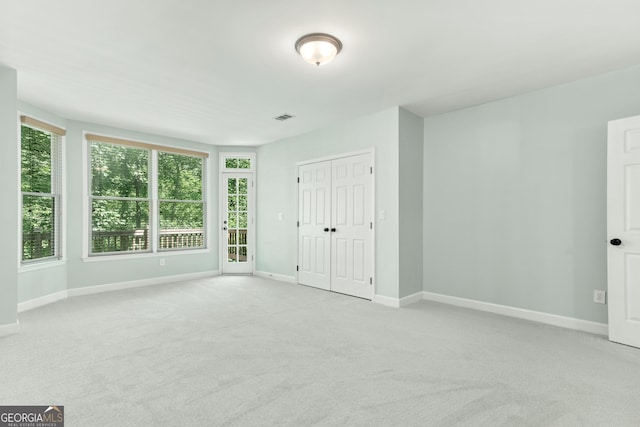 140 Longwater Cv, Roswell, GA 30075 - unfurnished bedroom featuring light carpet and a closet