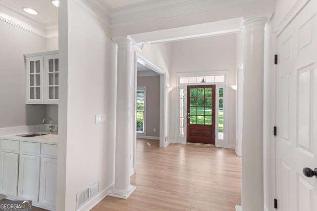 140 Longwater Cv, Roswell, GA 30075 - foyer featuring decorative columns, light wood-style flooring, and crown molding