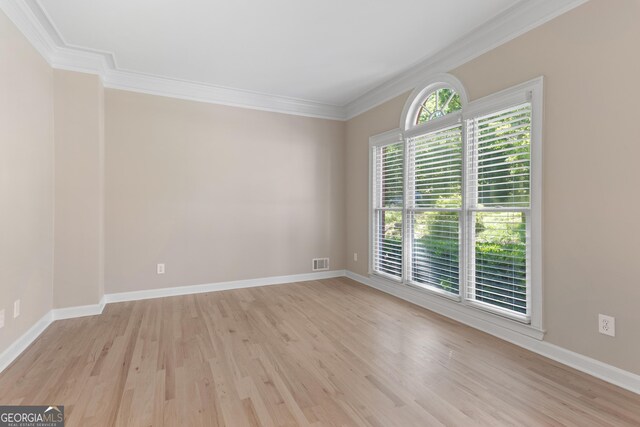 140 Longwater Cv, Roswell, GA 30075 - empty room with ornamental molding and light wood-type flooring
