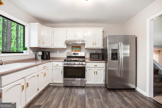 2022 Ramblewood Ct NE, Marietta, GA 30062 - kitchen featuring stainless steel appliances, under cabinet range hood, dark wood-style floors, white cabinetry, and light countertops