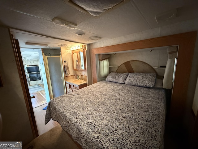 1031 Mountain Shadows Dr Unit 90A, Cleveland, GA 30528 - bedroom with wood finished floors, a sink, and ensuite bathroom