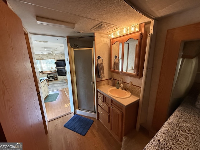 1031 Mountain Shadows Dr Unit 90A, Cleveland, GA 30528 - full bath with vanity, wood finished floors, and a shower stall
