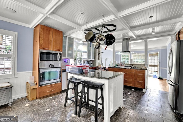3897 Tanbark Ct, Marietta, GA 30066 - kitchen featuring stainless steel appliances, brown cabinets, coffered ceiling, a wainscoted wall, and a kitchen island