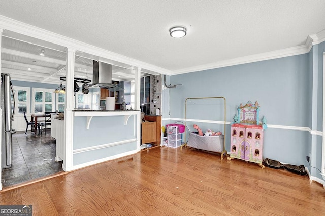 3897 Tanbark Ct, Marietta, GA 30066 - interior space featuring island range hood, ornamental molding, wood finished floors, beam ceiling, and coffered ceiling