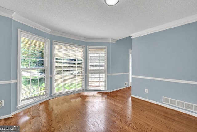 3897 Tanbark Ct, Marietta, GA 30066 - spare room with a textured ceiling, ornamental molding, and wood finished floors