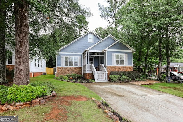 1860 Old W Broad St, Athens, GA 30606 - craftsman inspired home featuring stone siding, a front yard, a sunroom, and driveway