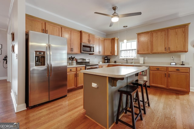 1860 Old W Broad St, Athens, GA 30606 - kitchen featuring appliances with stainless steel finishes, a ceiling fan, a kitchen island, a kitchen breakfast bar, and light countertops