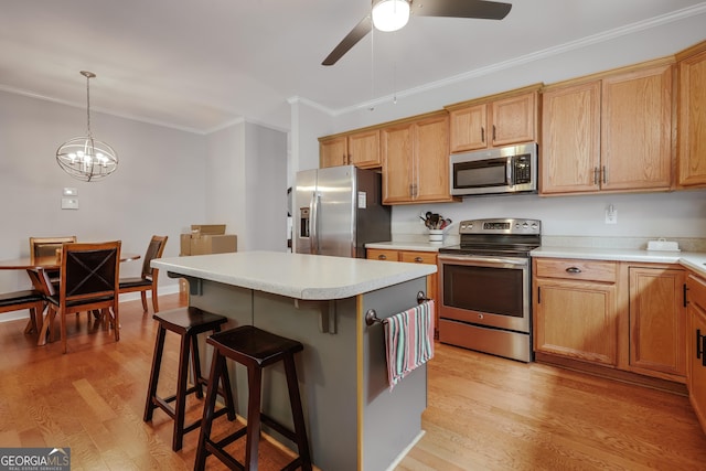 1860 Old W Broad St, Athens, GA 30606 - kitchen featuring appliances with stainless steel finishes, crown molding, a ceiling fan, a breakfast bar area, and light wood finished floors