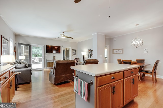 1860 Old W Broad St, Athens, GA 30606 - kitchen featuring a ceiling fan, light wood finished floors, crown molding, a kitchen island, and open floor plan
