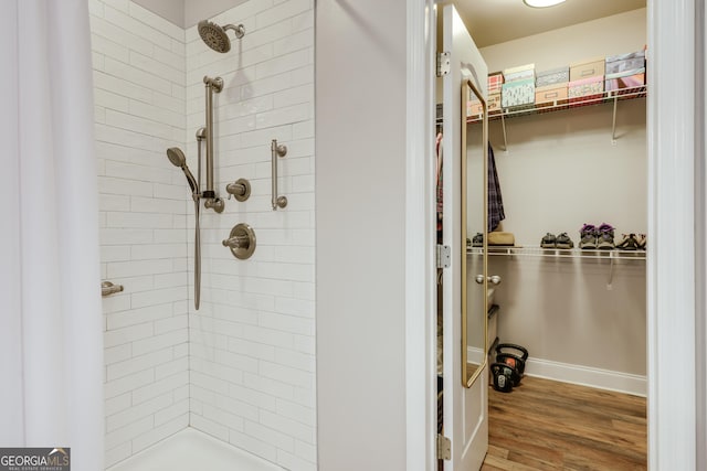 1860 Old W Broad St, Athens, GA 30606 - bathroom with a walk in closet, a tile shower, wood finished floors, and baseboards