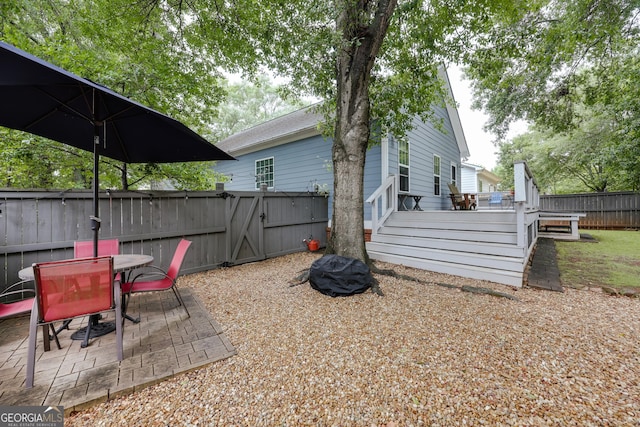 1860 Old W Broad St, Athens, GA 30606 - fenced backyard with a wooden deck, outdoor dining area, a gate, and a patio