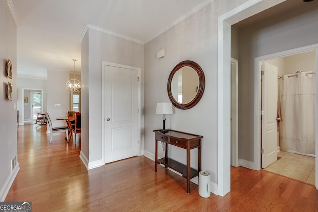 1860 Old W Broad St, Athens, GA 30606 - hall with light wood-type flooring, a chandelier, ornamental molding, and baseboards
