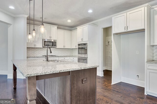 1231 Fawndale Dr NW, Kennesaw, GA 30152 - kitchen with appliances with stainless steel finishes, dark wood-style flooring, light stone counters, decorative backsplash, and white cabinetry